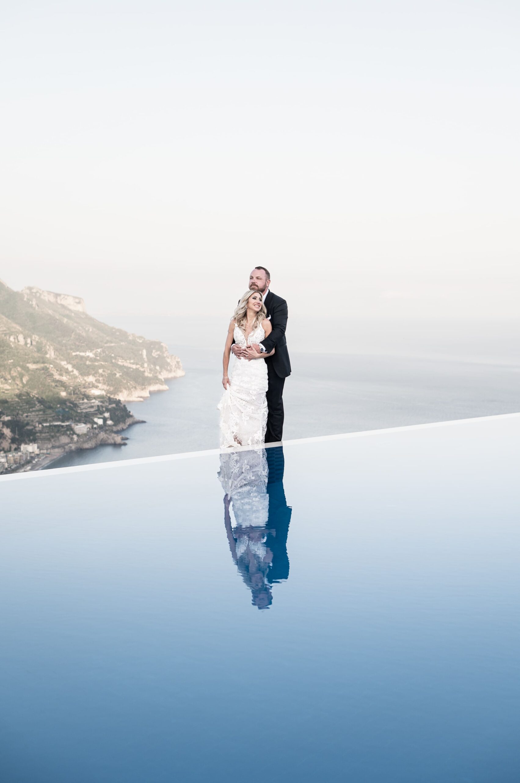 Newlyweds' reflection in the pool of Belmond Caruso: a Dream Wedding Above the Amalfi Coast