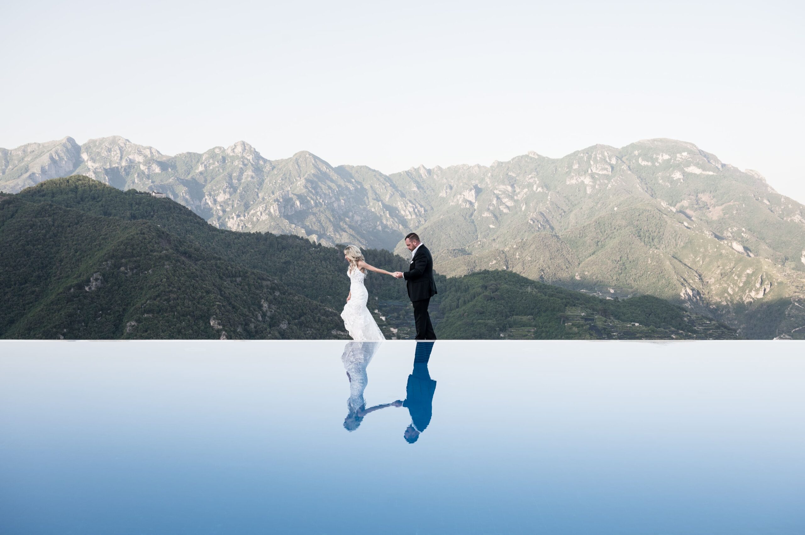 Newlyweds' reflection in the pool of Belmond Caruso: a Dream Wedding Above the Amalfi Coast
