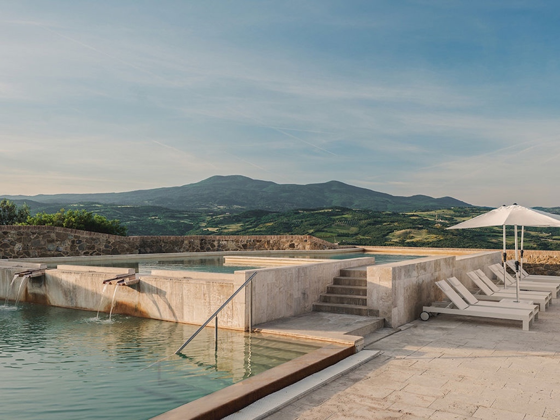 The pool of Castello di Velona with a view on Val d'Orcia