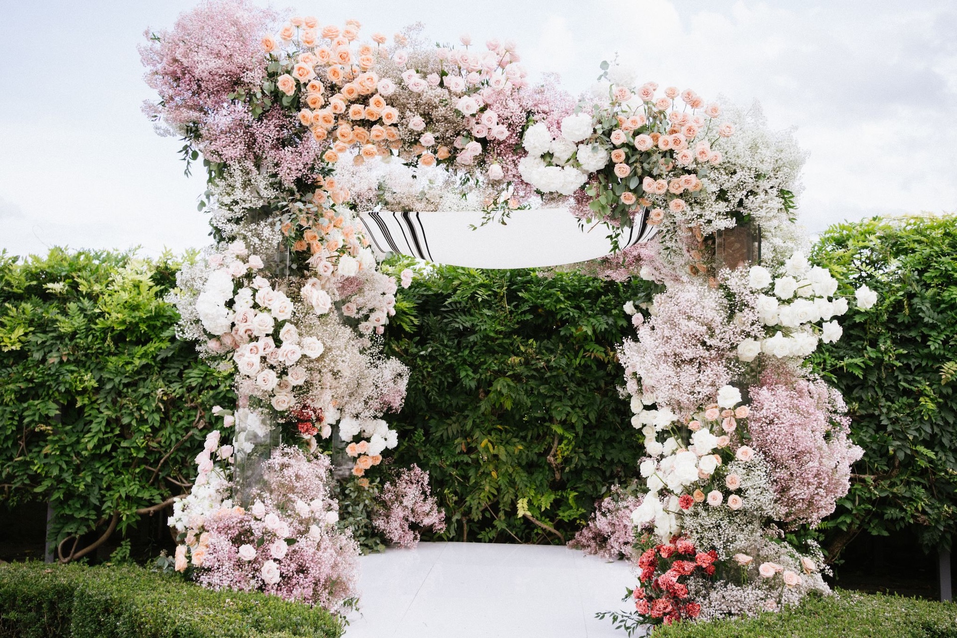 Che Chic - Destination wedding Italy - Home - Masterpieces 6 A sculptural chuppah overflowing with roses, baby’s breath, and hydrangeas in soft pastel tones