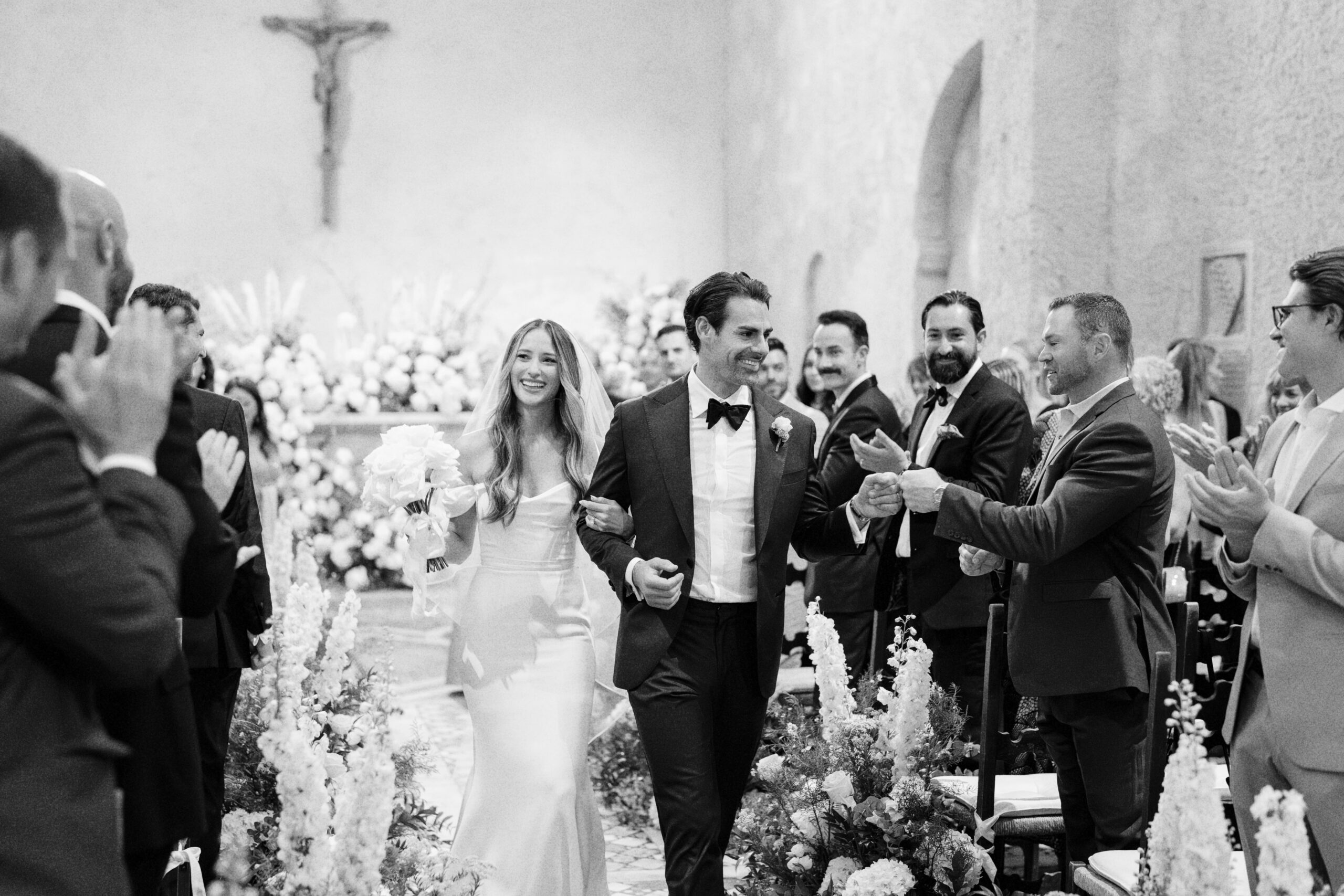 A black and white portrait of bride and groom in the church's aisle of La Badia di Orvieto, Destination wedding venue in Umbria