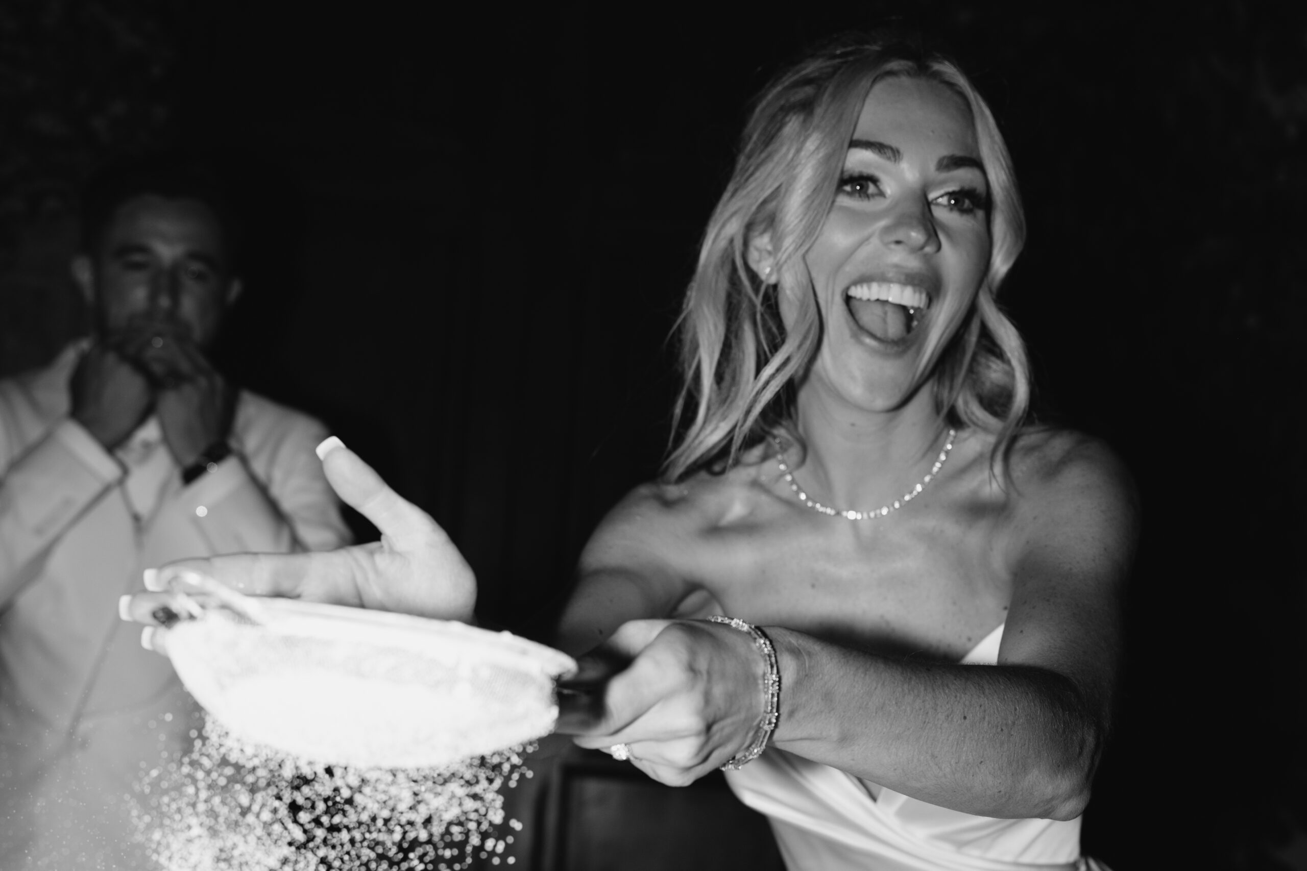 A live cake preparation with the bride